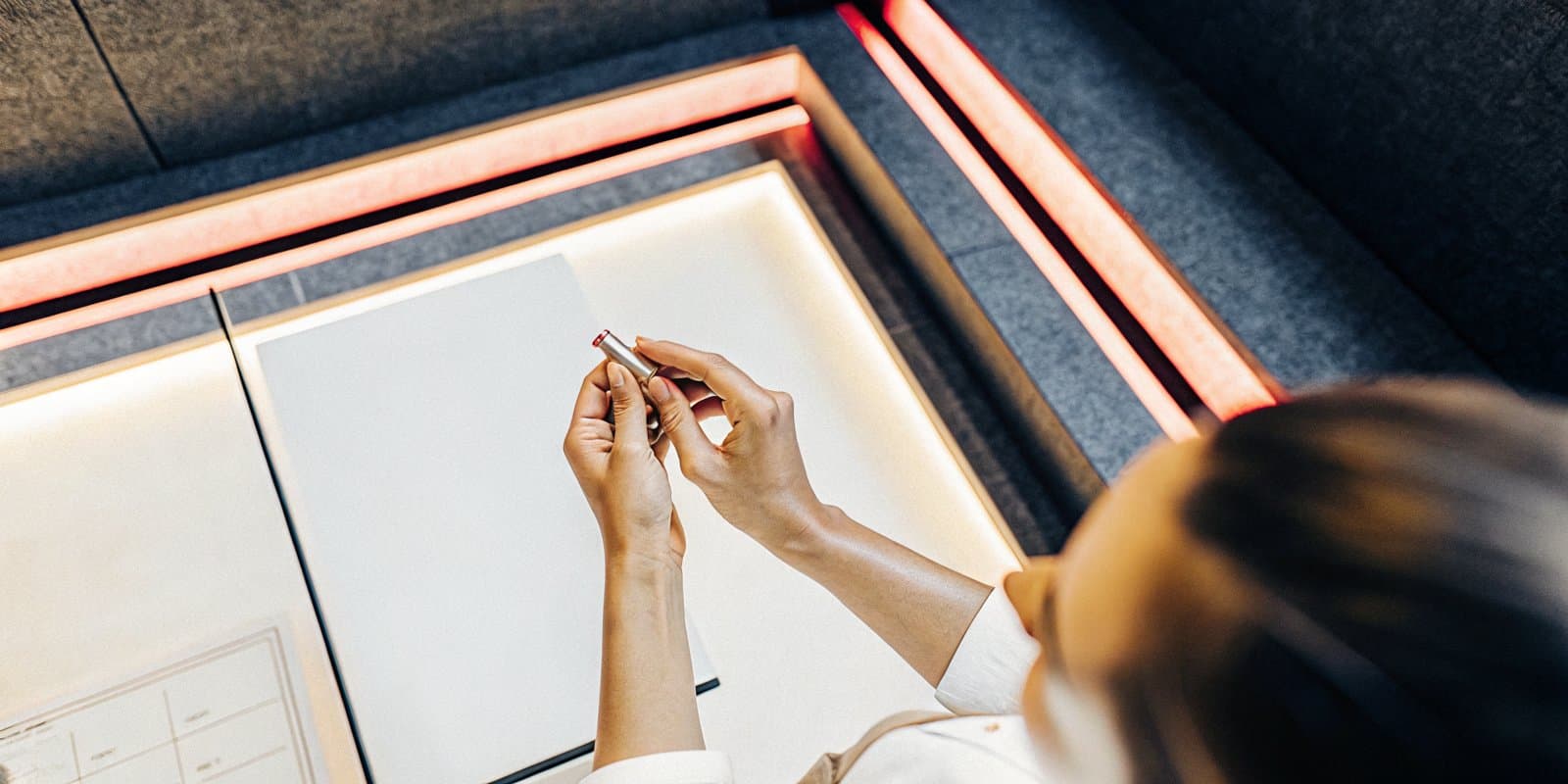 A woman journaling in a calm, warmly lit Infinite Vitality consultation space