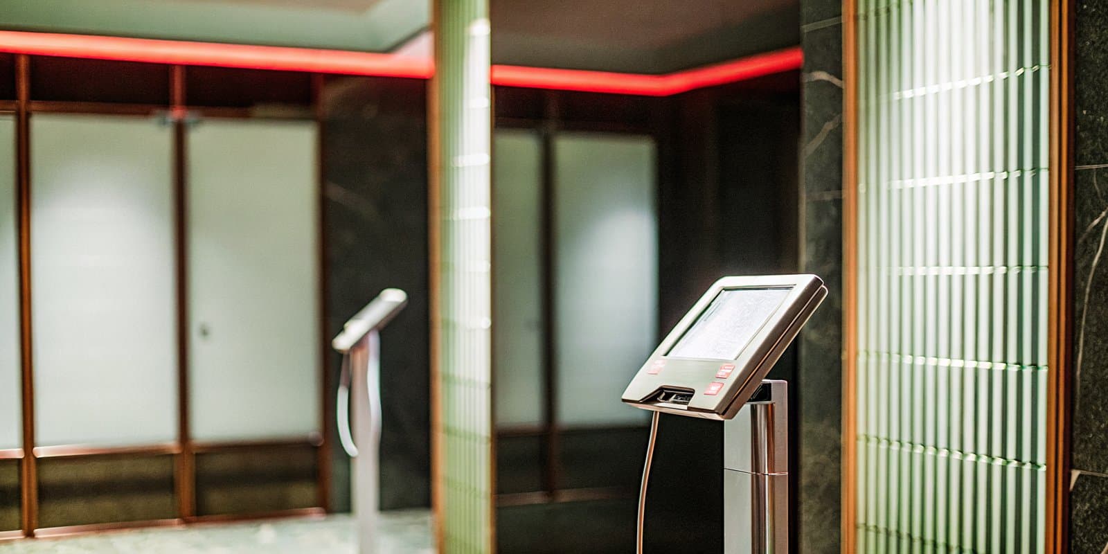 A body-composition scanner in the dark, red-lit Infinite Vitality clinic